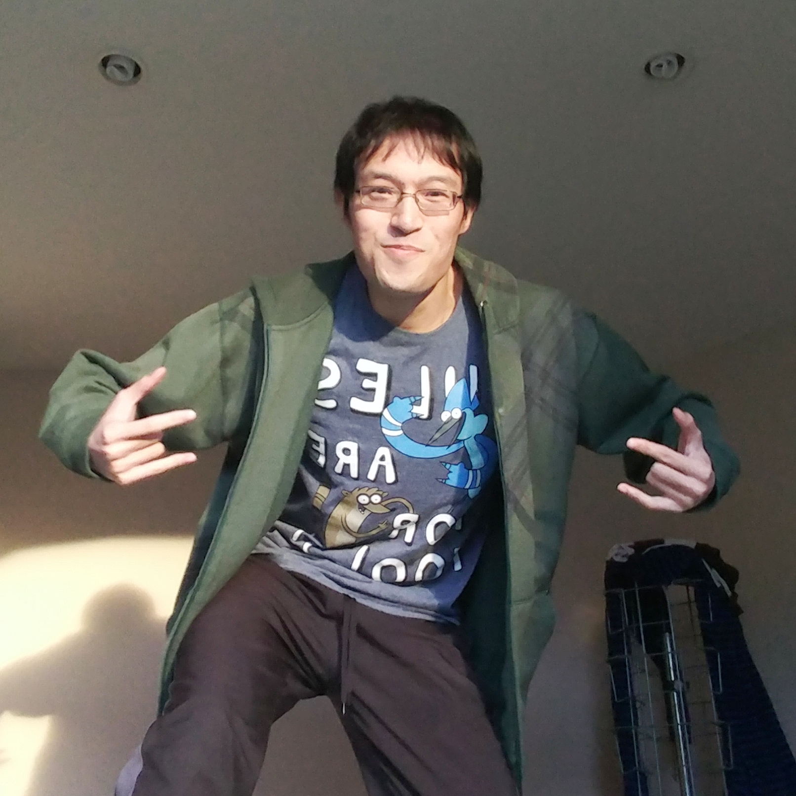 Chris doing a “gangsta” pose, smiling